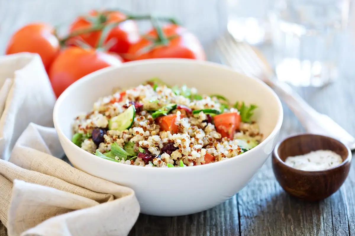 Colorful quinoa salad bowl with fresh vegetables and lemon dressing